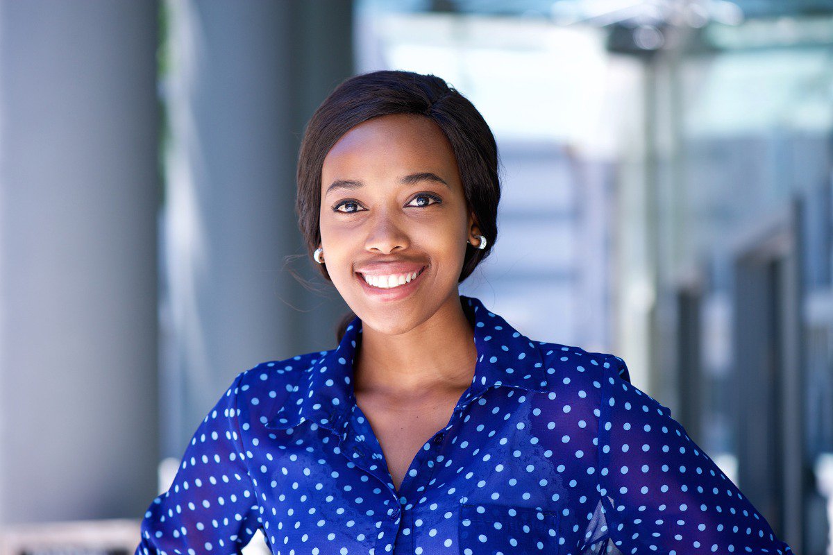 A woman smiling brightly, showcasing her gleaming teeth