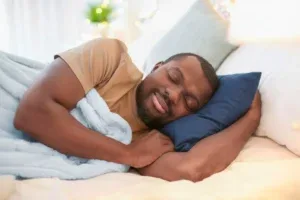 Man sleeping peacefully on his side in bed