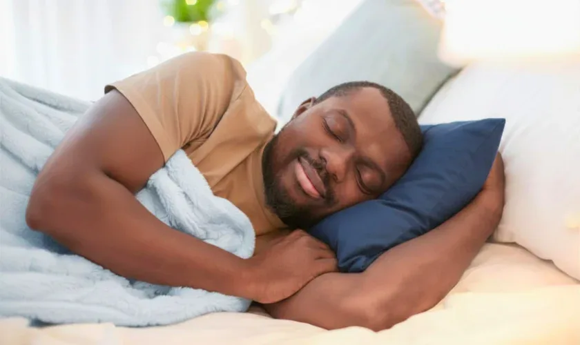 Man sleeping peacefully on his side in bed